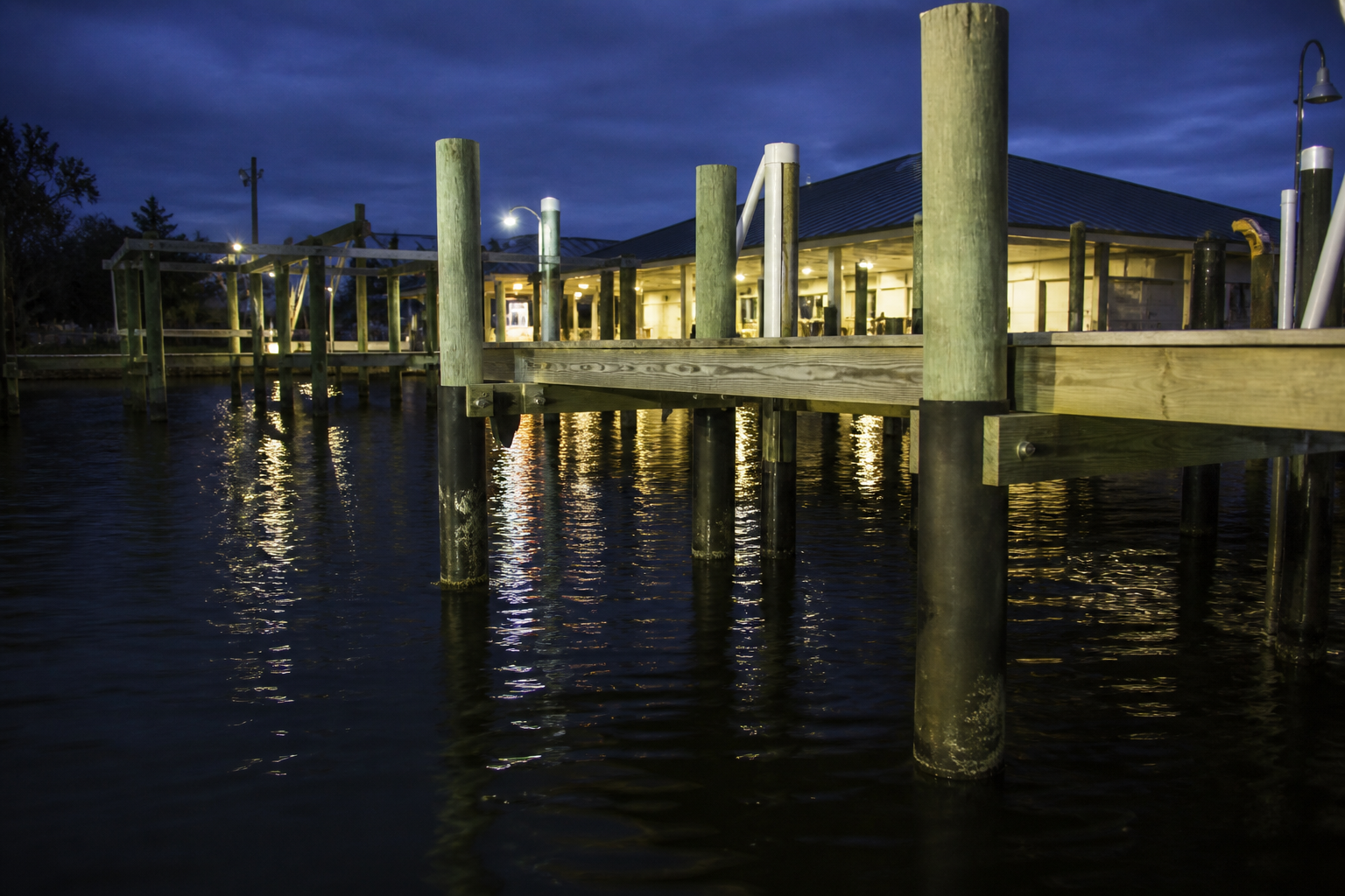 Placeholder photograph (synthetic): Gulf pier with vinyl piling jackets at dusk